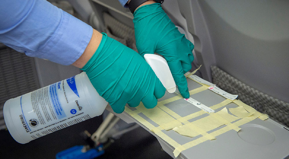 Tray table being treated with an antimicrobial coating to test against MS2 Virus